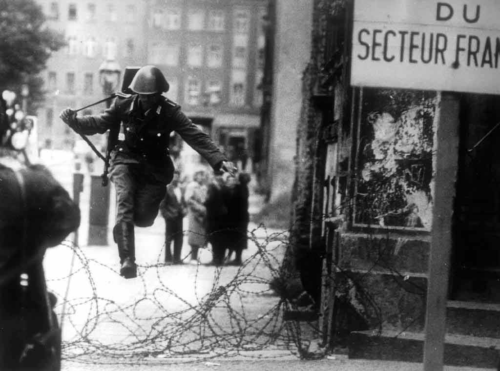 A soldier of the East German National People's Army makes a dash for freedom 1961